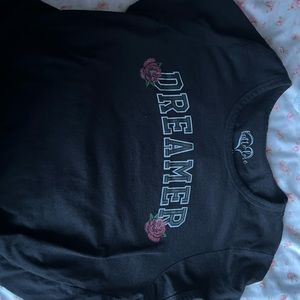 It’s a black shirt that says dreamer on it size medium
